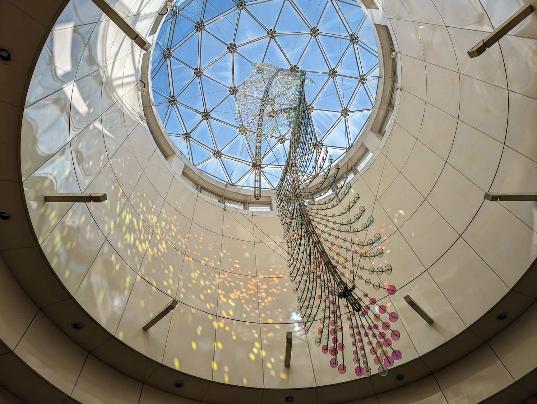 A stunning view of a light-reflective art installation within a geometric skylight in New Taipei City, Taiwan.